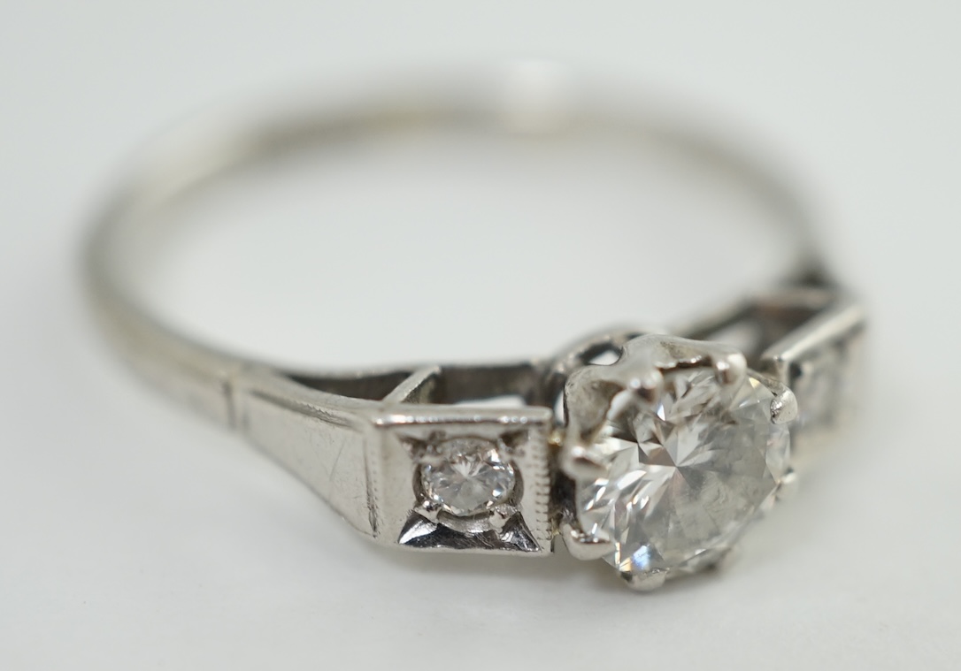 A 1920's/1930's platinum and single stone diamond set ring, with two stone diamond set shoulders